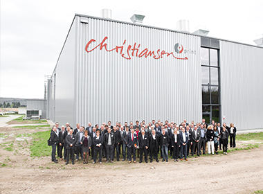 A group of people in front of the Christiansen Print building