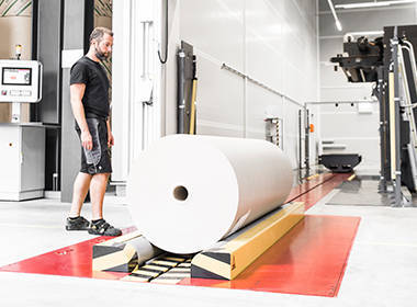 An employee shows the function of the new petras railsystem at the digital printer.